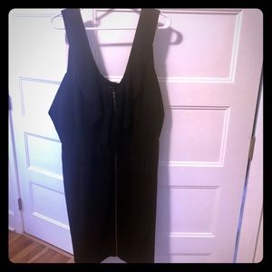 Black ruffled front tunic with pockets and zipper